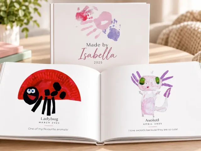 A closed keepsake book next to an open copy showing a paper-plate ladybug craft and an axolotl drawing